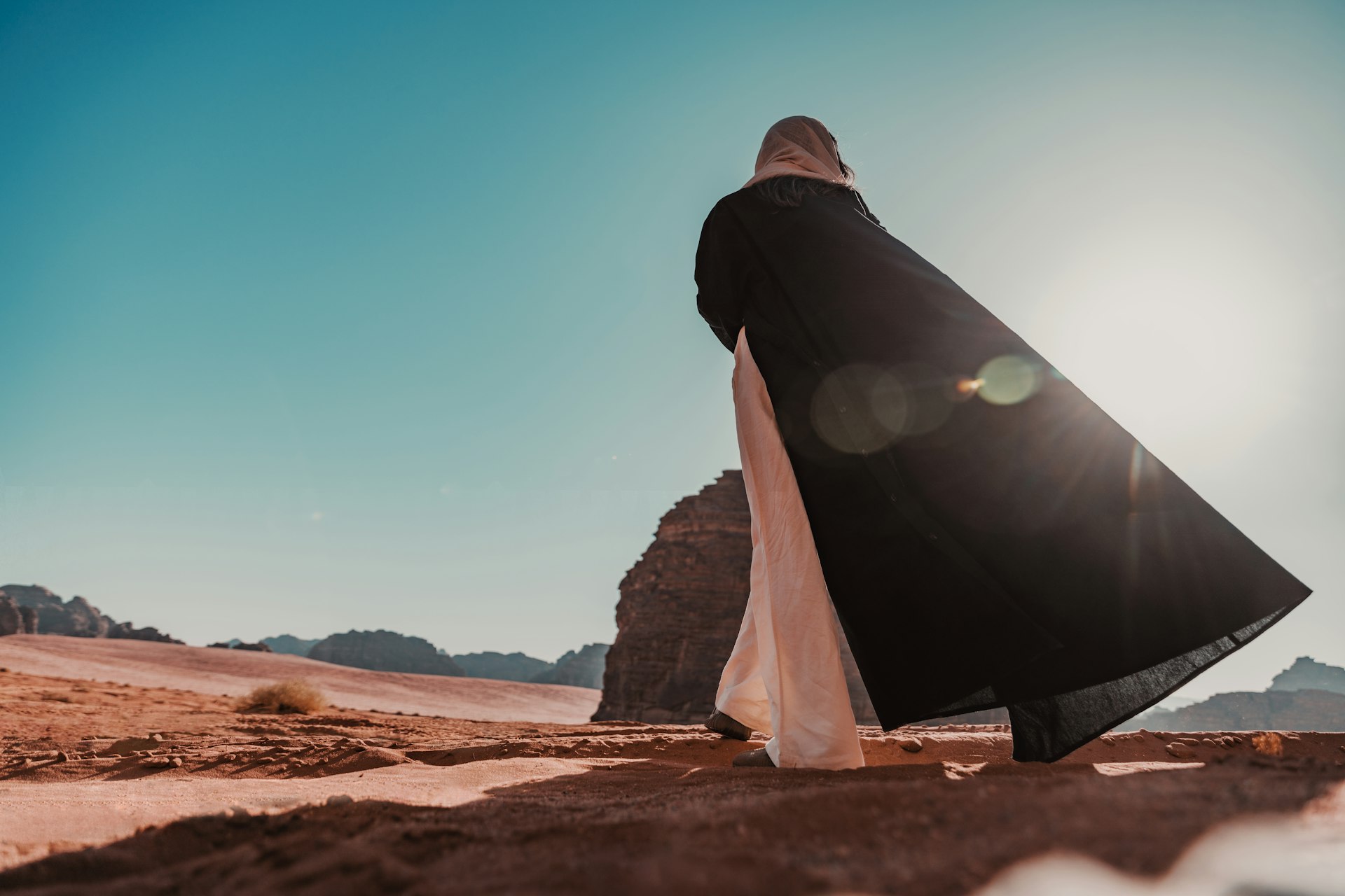 Person walking in a desert landscape in Saudi Arabia